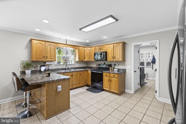a kitchen with a sink refrigerator and cabinets