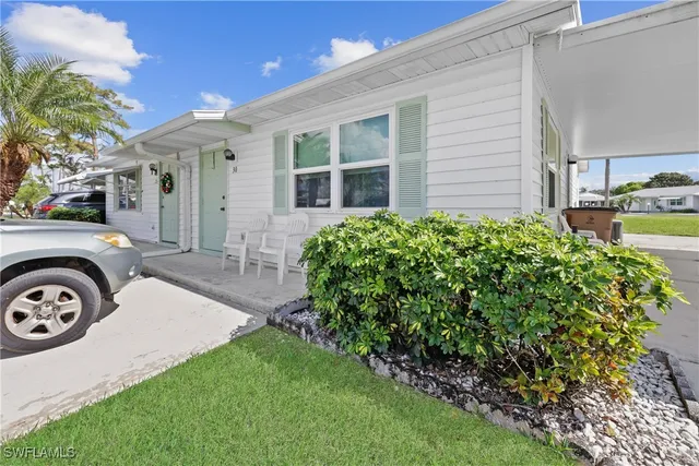 a view of a bedroom with furniture and a window