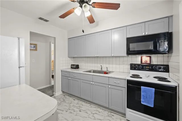 a kitchen with stainless steel appliances a stove sink microwave and cabinets
