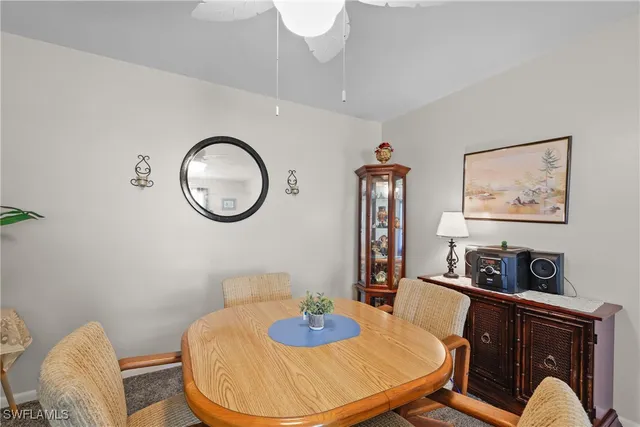 a living room with furniture and a mirror