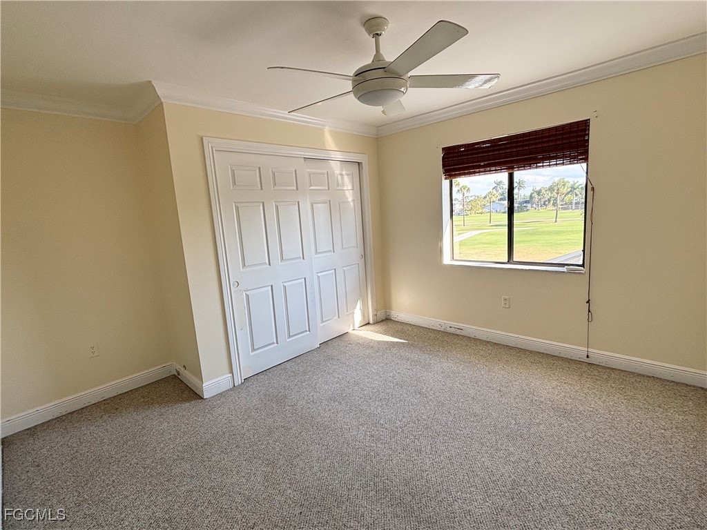 7280 Pebble Beach Road Fort Myers, FL 33967 - Photo 14 of 15 an empty room with a ceiling fan and a window