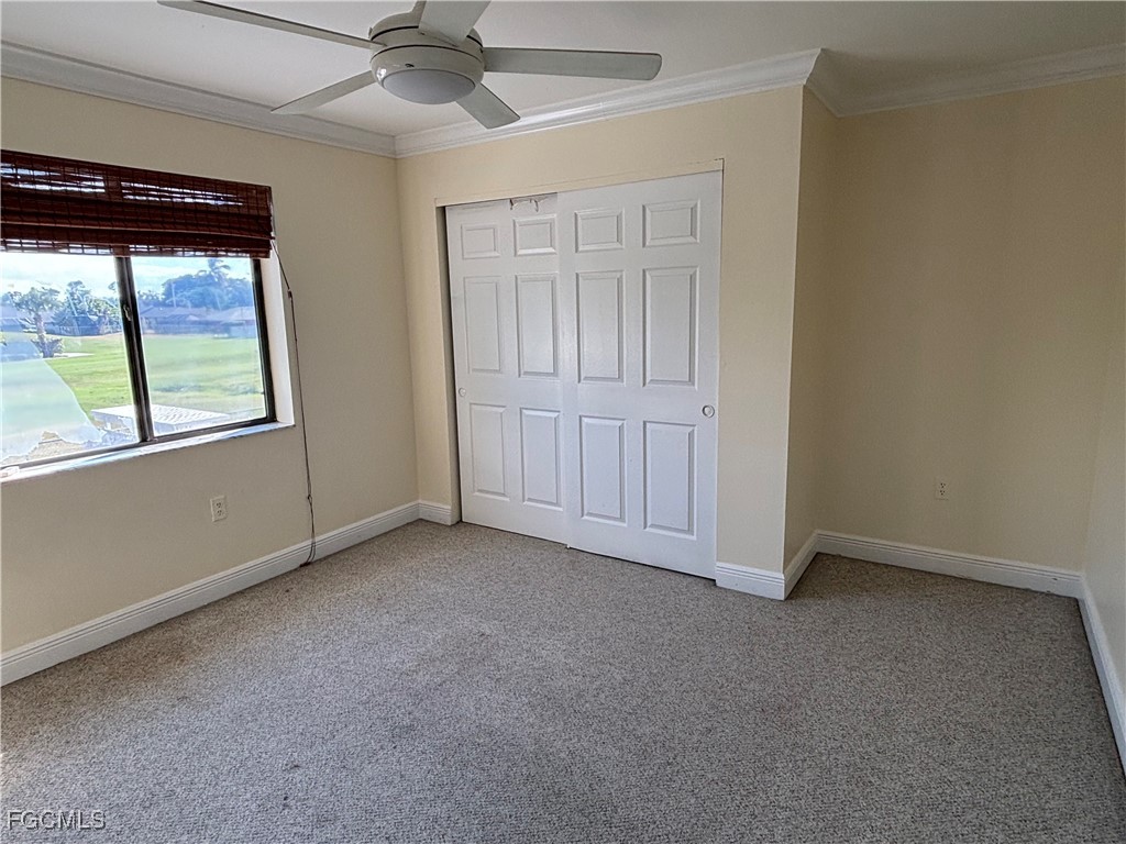7280 Pebble Beach Road Fort Myers, FL 33967 - Photo 15 of 15 an empty room with a window and ceiling fan