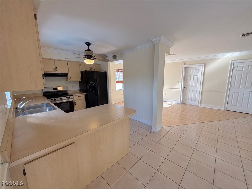 7280 Pebble Beach Road Fort Myers, FL 33967 - Photo 8 of 15 a kitchen view with stainless steel appliances a refrigerator and a stove top oven