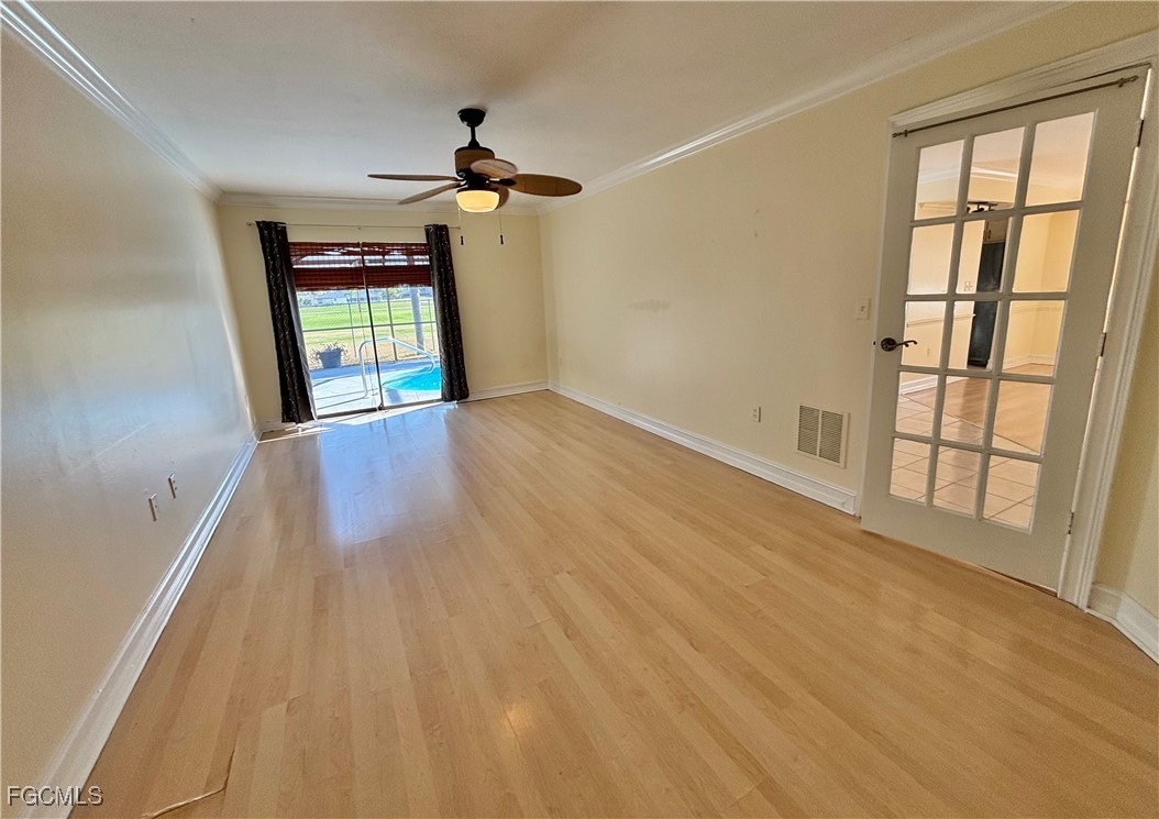 7280 Pebble Beach Road Fort Myers, FL 33967 - Photo 10 of 15 wooden floor in an empty room with a window