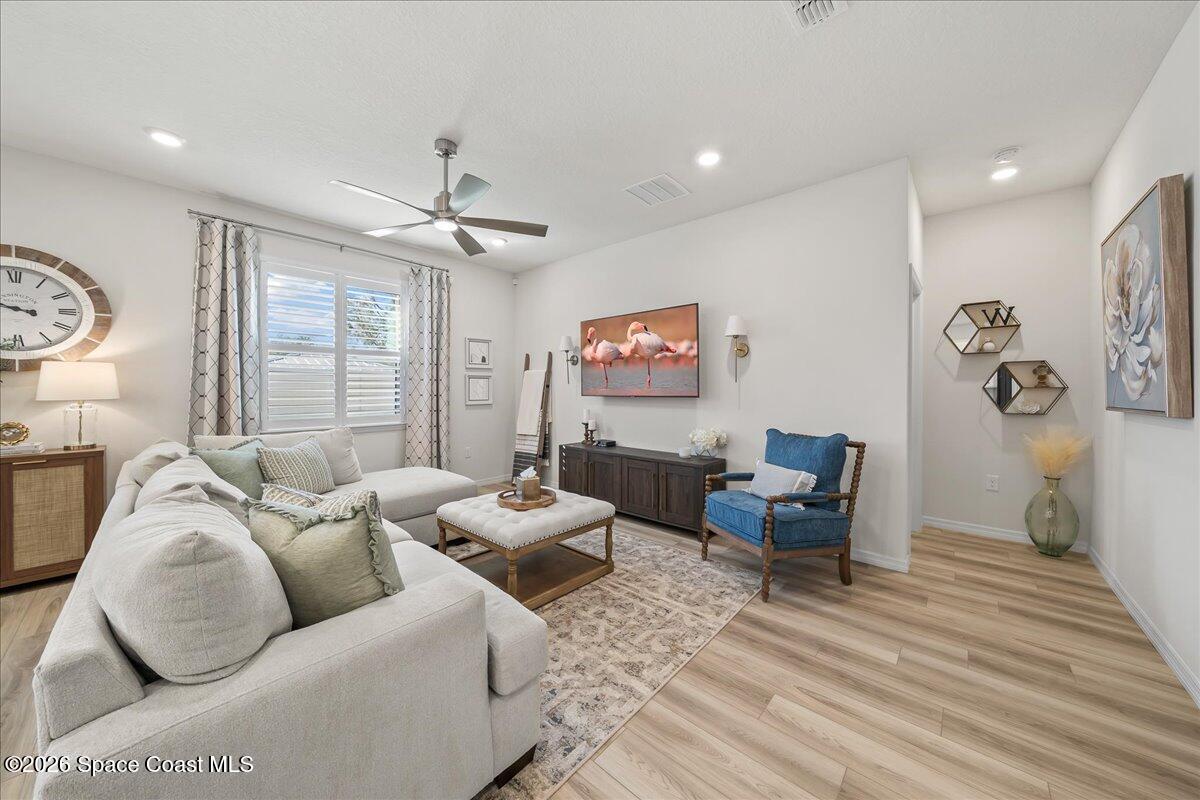 881 Covington Court Rockledge, FL 32955 - Photo 13 of 30 a living room with furniture and a chandelier