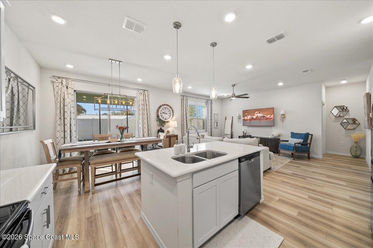 881 Covington Court Rockledge, FL 32955 - Photo 14 of 30 a kitchen with a sink stove and wooden floor