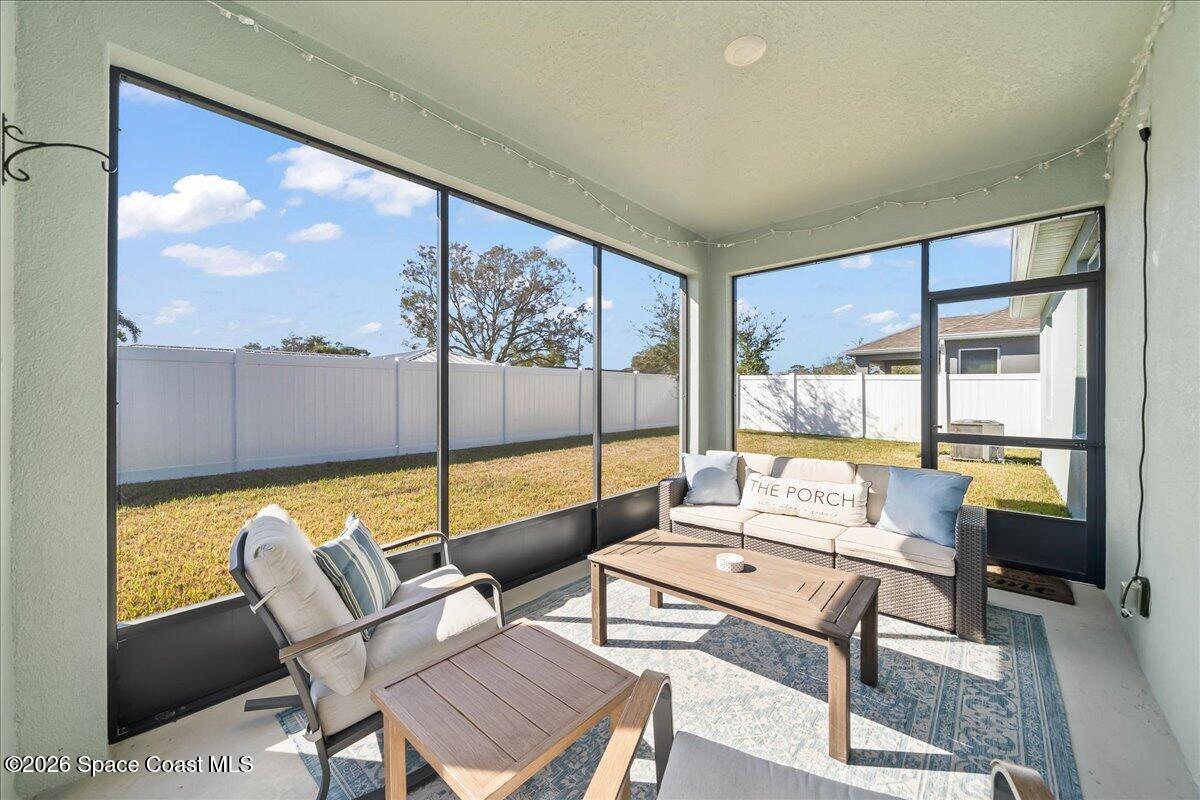 881 Covington Court Rockledge, FL 32955 - Photo 16 of 30 a living room with furniture and a floor to ceiling window