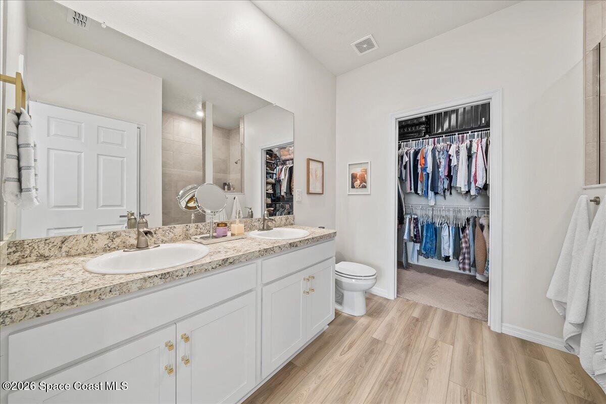 881 Covington Court Rockledge, FL 32955 - Photo 20 of 30 a spacious bathroom with a granite countertop sink and a mirror