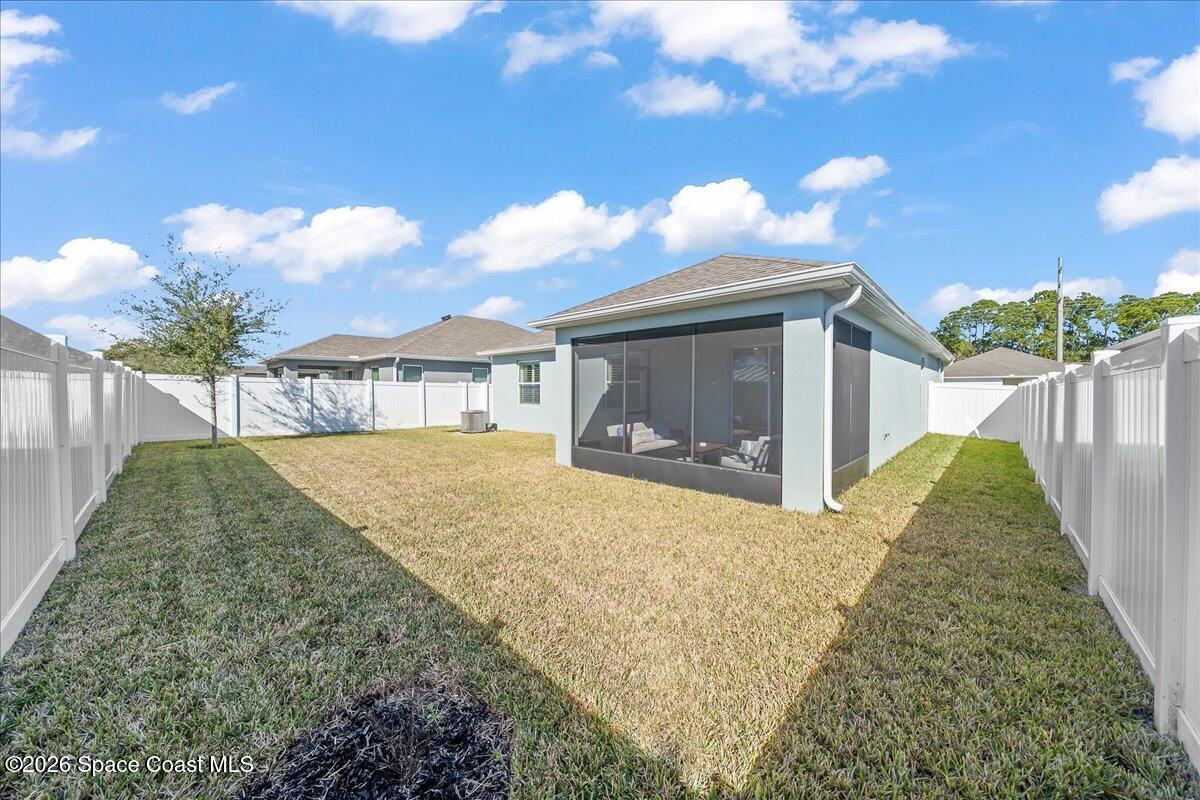 881 Covington Court Rockledge, FL 32955 - Photo 26 of 30 a front view of a house with a yard and garage