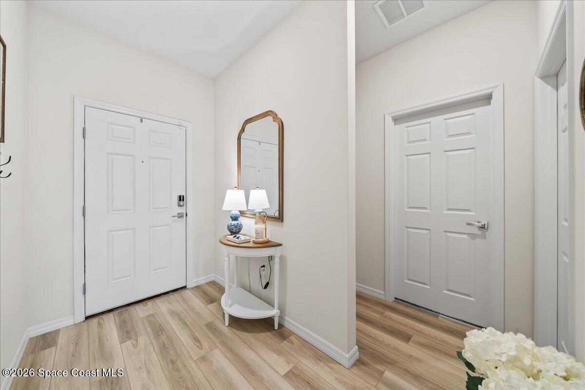 881 Covington Court Rockledge, FL 32955 - Photo 5 of 30 a view of a bathroom with sink mirror and wooden floor