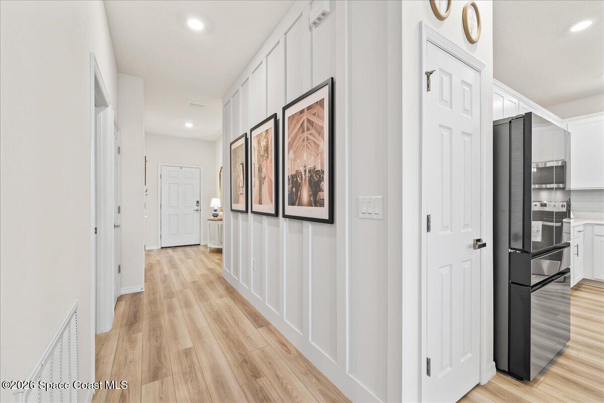 881 Covington Court Rockledge, FL 32955 - Photo 6 of 30 a view of a hallway with wooden floor