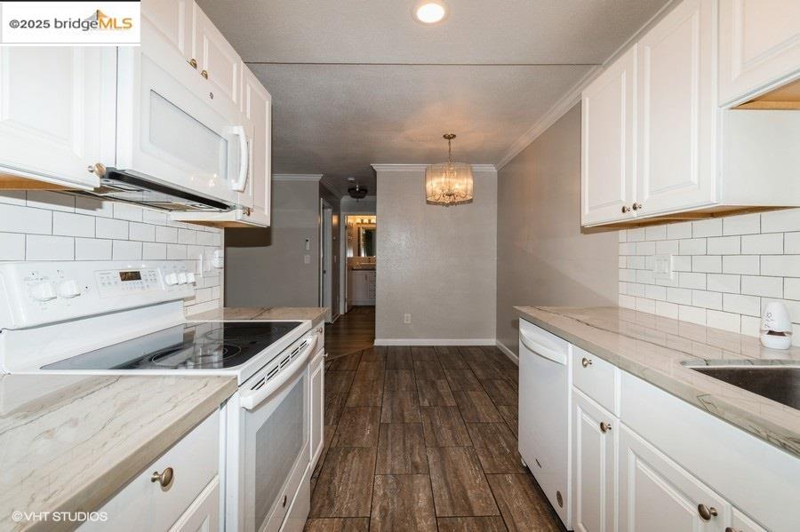 1505 Kirker Pass Road, Unit 170 Concord, CA 94521 - Photo 10 of 18 Kitchen featuring backsplash, white appliances, white cabinets, and crown molding