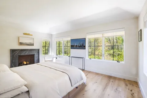 a spacious bedroom with a large bed and a fireplace