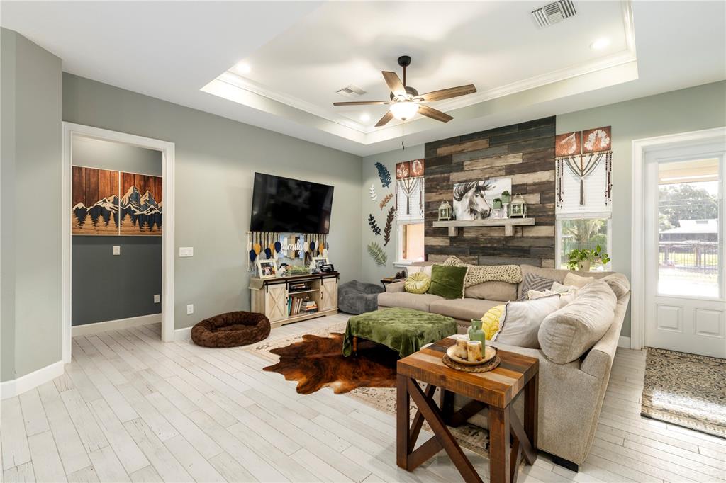 35638 Calla Court Leesburg, FL 34788 - Photo 17 of 44 a living room with furniture and a flat screen tv