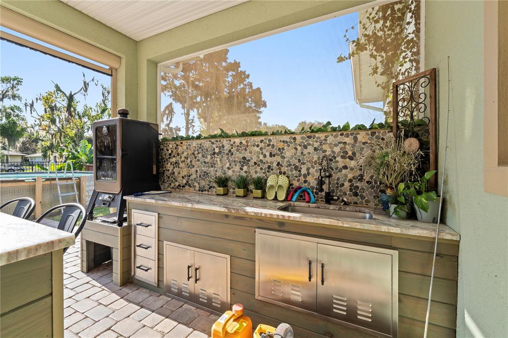 35638 Calla Court Leesburg, FL 34788 - Photo 26 of 44 a view of a kitchen with stainless steel appliances wooden floor and a large window