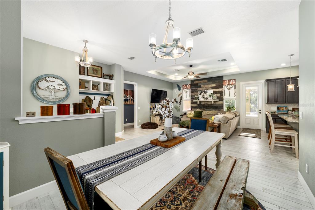 35638 Calla Court Leesburg, FL 34788 - Photo 7 of 44 a view of a dining room with furniture a chandelier and wooden floor