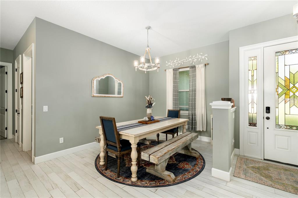 35638 Calla Court Leesburg, FL 34788 - Photo 8 of 44 a view of a dining room with furniture window and wooden floor