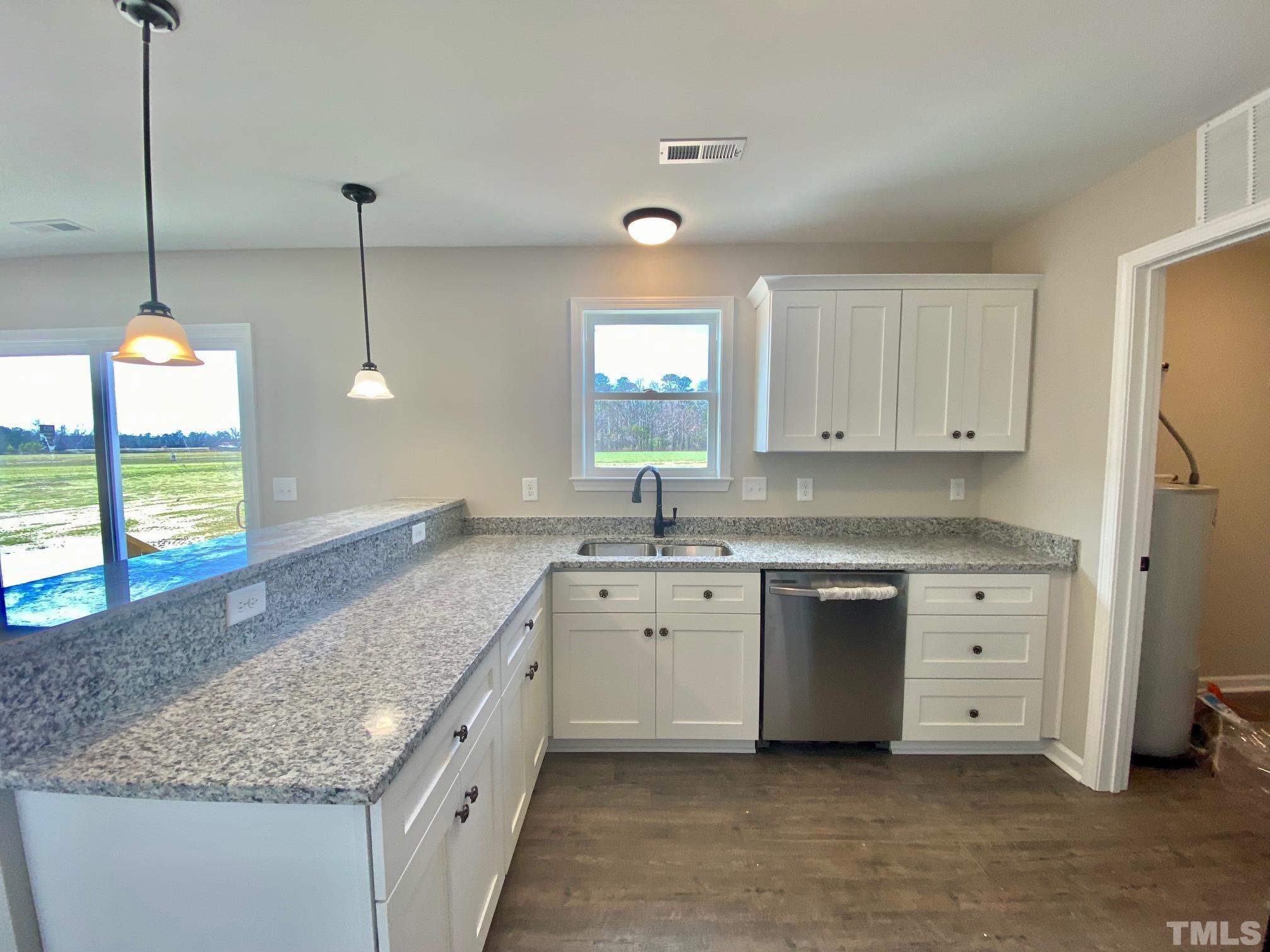 136 Mamie Road Benson, NC 27504 - Photo 15 of 32 a kitchen with granite countertop a sink a counter space appliances and cabinets