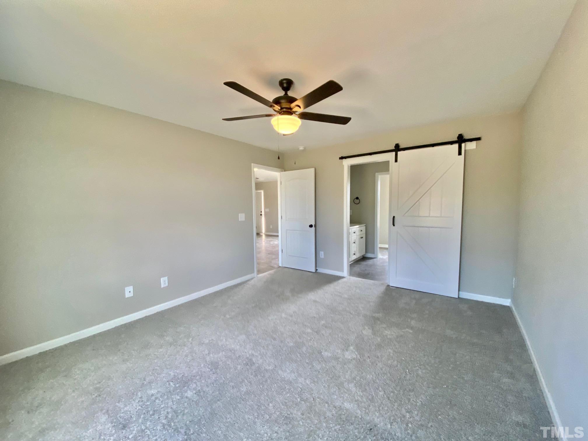 136 Mamie Road Benson, NC 27504 - Photo 19 of 32 a view of a big room with chandelier fan and windows