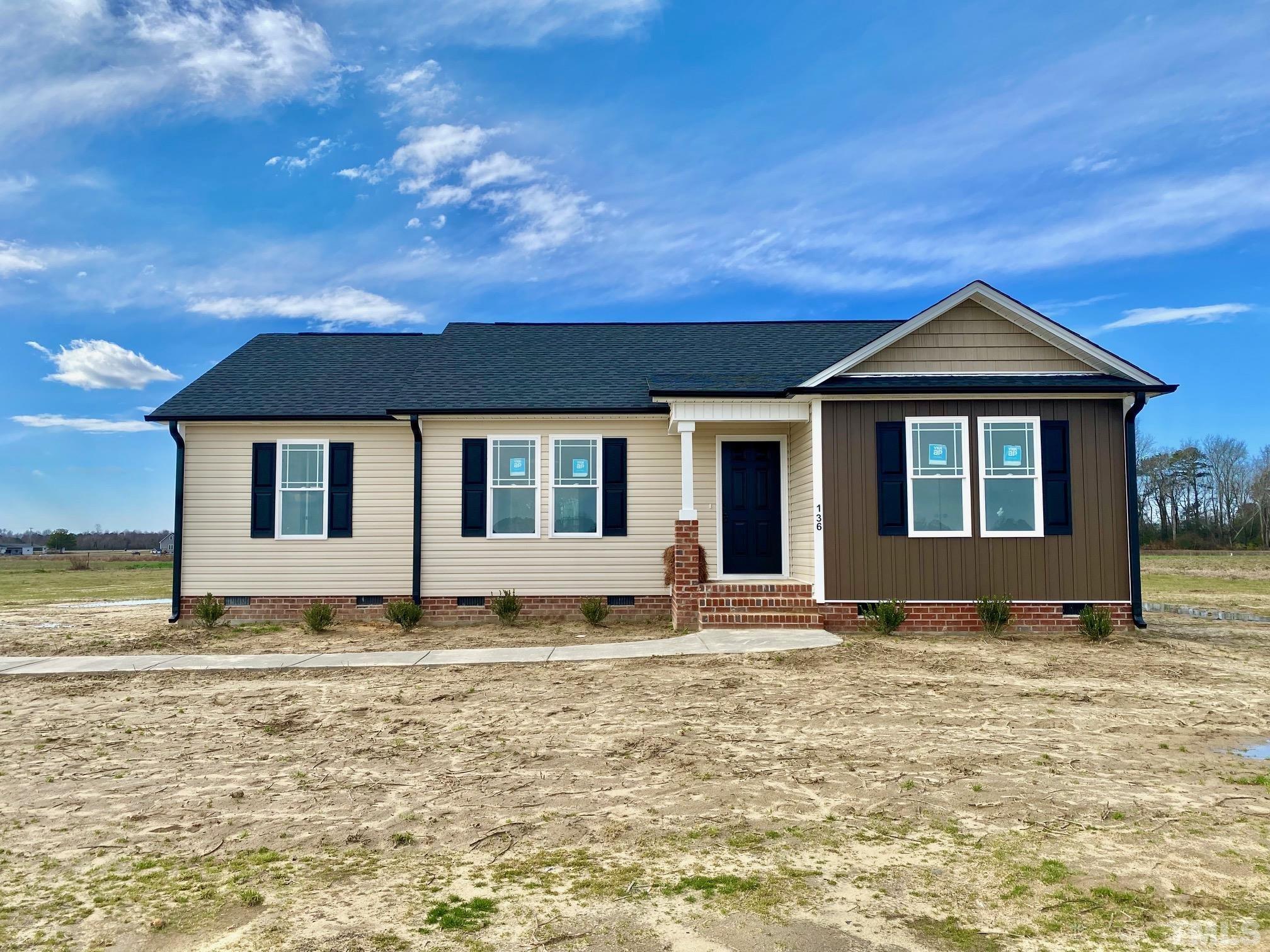 136 Mamie Road Benson, NC 27504 - Photo 2 of 32 a front view of a house with a yard