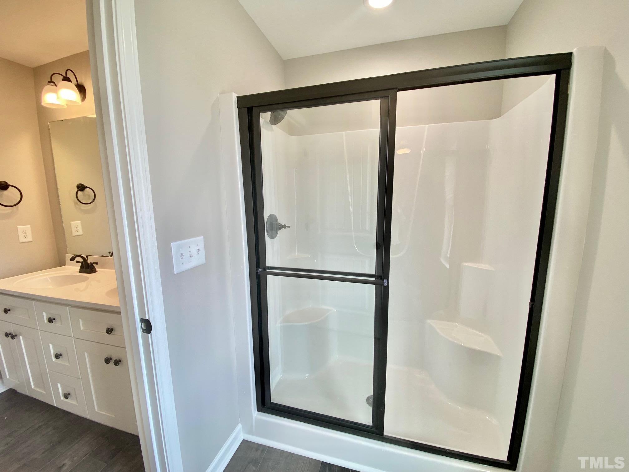 136 Mamie Road Benson, NC 27504 - Photo 22 of 32 a bathroom with a glass shower door