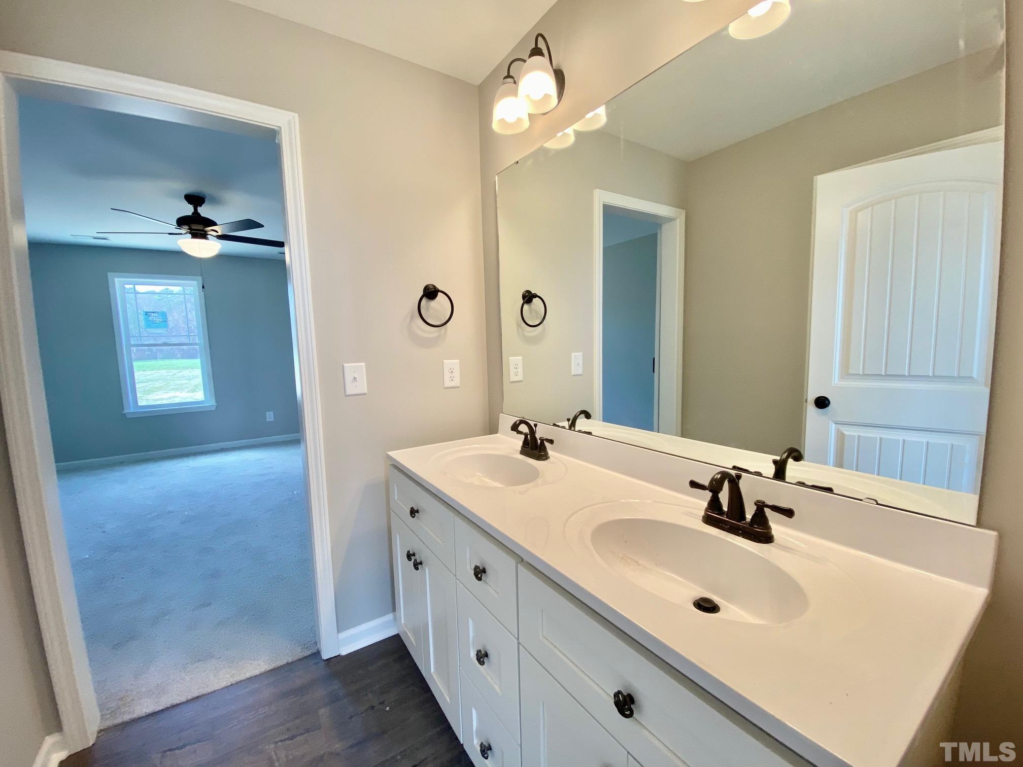 136 Mamie Road Benson, NC 27504 - Photo 23 of 32 a bathroom with a sink a light fixture and a mirror