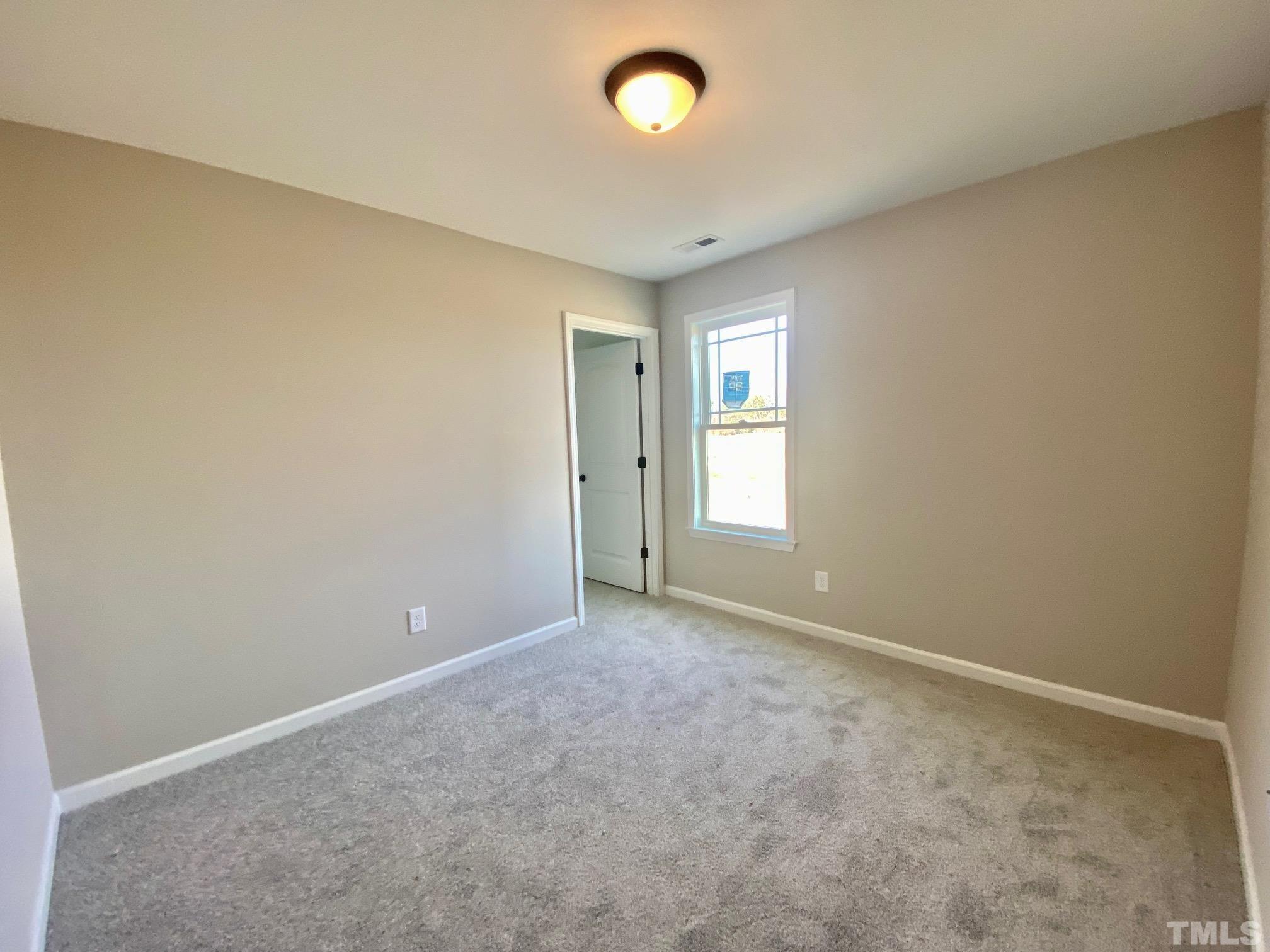 136 Mamie Road Benson, NC 27504 - Photo 25 of 32 a view of an empty room with a window