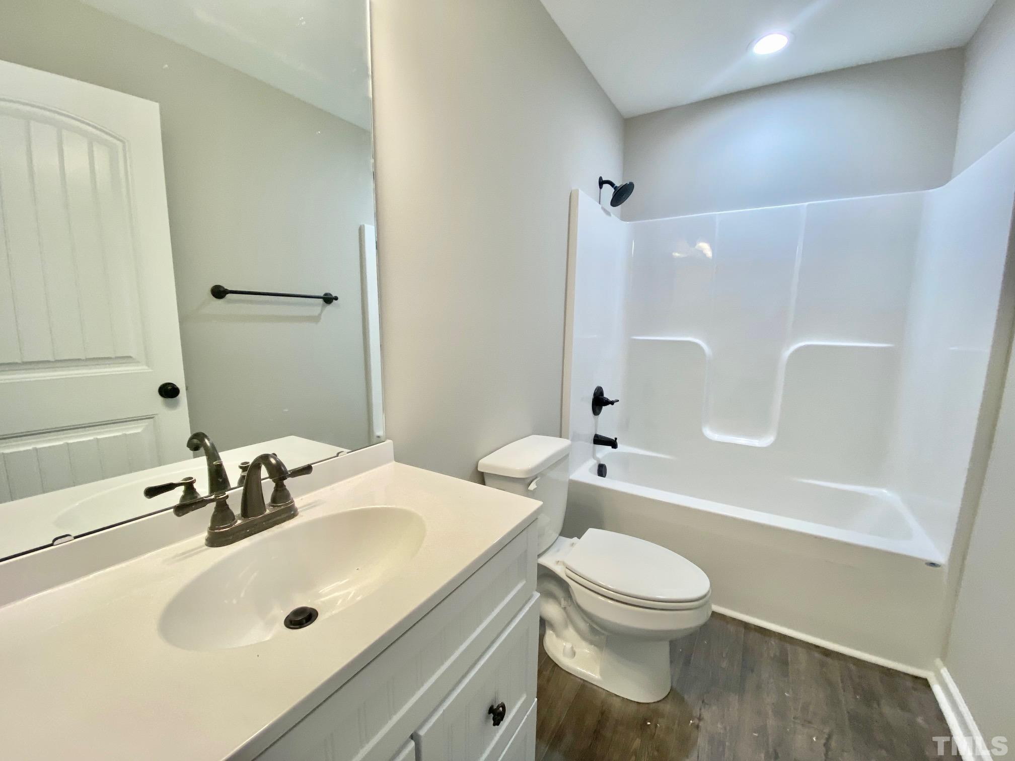 136 Mamie Road Benson, NC 27504 - Photo 27 of 32 a bathroom with a sink a toilet and a mirror