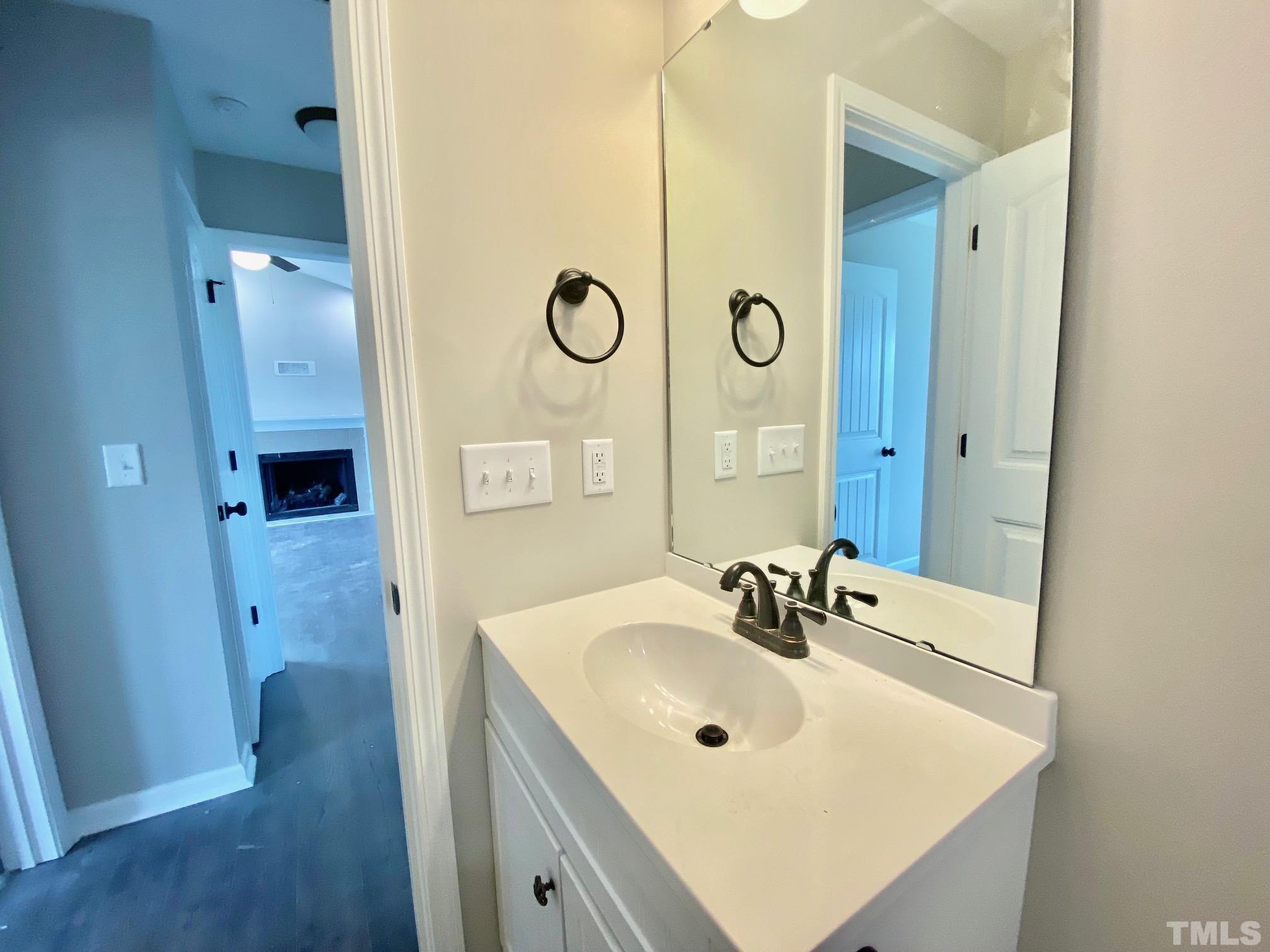 136 Mamie Road Benson, NC 27504 - Photo 28 of 32 a bathroom with a sink and a mirror