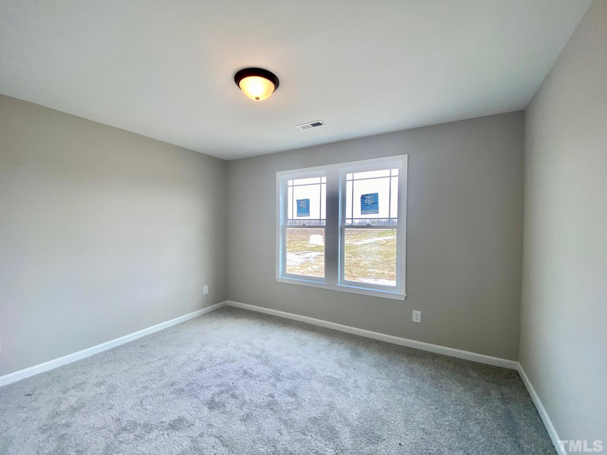 136 Mamie Road Benson, NC 27504 - Photo 29 of 32 an empty room with windows