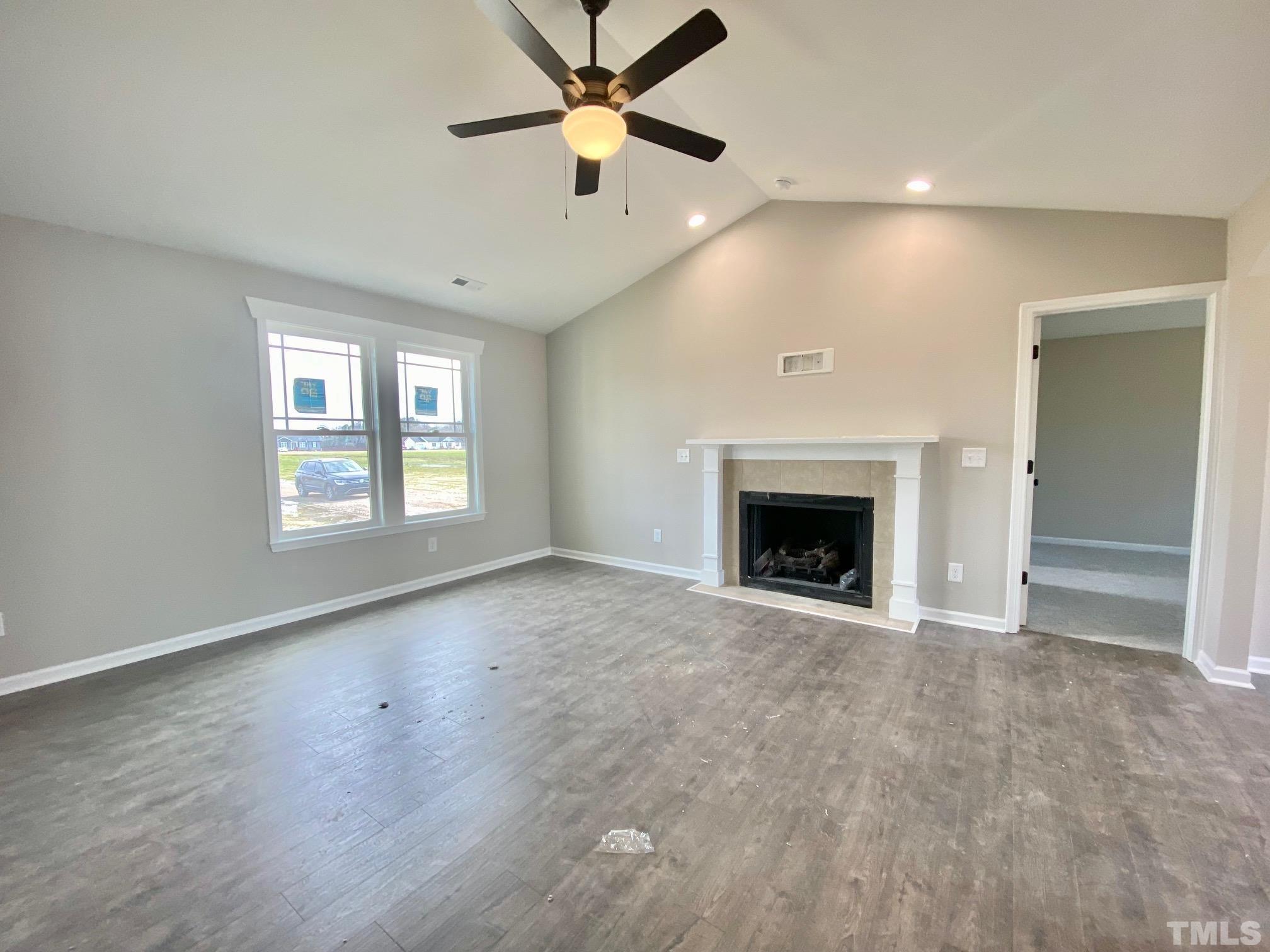 136 Mamie Road Benson, NC 27504 - Photo 6 of 32 an empty room with windows and fireplace