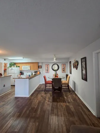 a living room with furniture and a dining table