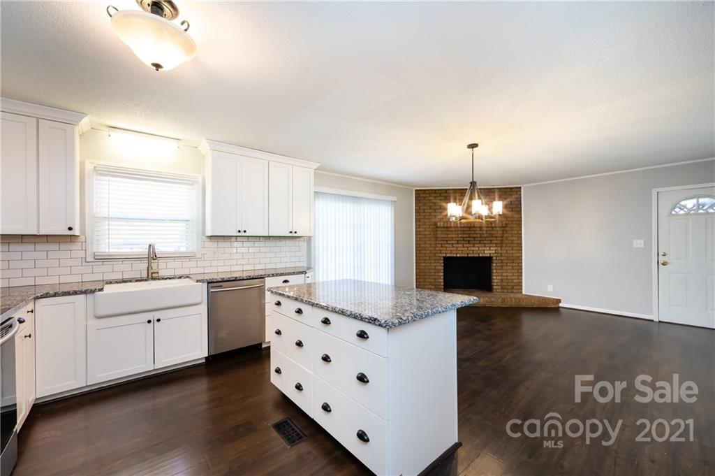 4003 Beaty Road Gastonia, NC 28056 - Photo 12 of 41 a large kitchen with granite countertop a sink cabinets and wooden floor