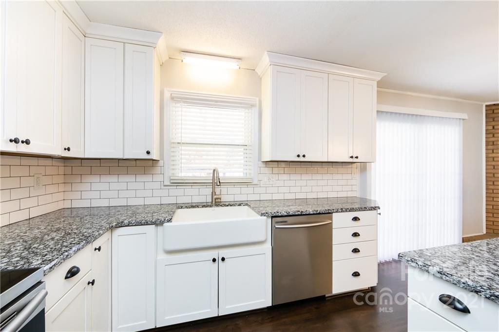 4003 Beaty Road Gastonia, NC 28056 - Photo 13 of 41 a kitchen with granite countertop white cabinets and white appliances