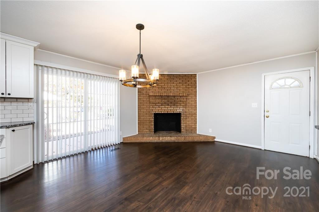 4003 Beaty Road Gastonia, NC 28056 - Photo 16 of 41 a view of a livingroom with wooden floor a fireplace and windows