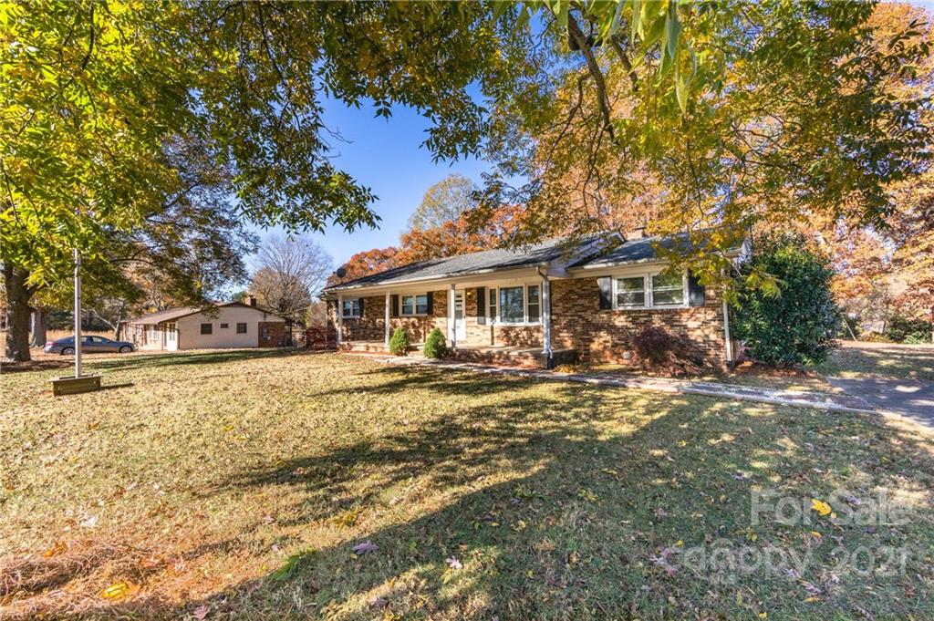 4003 Beaty Road Gastonia, NC 28056 - Photo 3 of 41 a front view of a house with a yard tree and outdoor seating