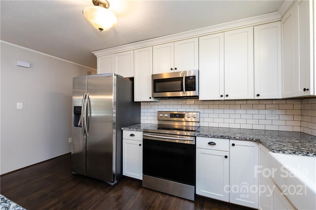 4003 Beaty Road Gastonia, NC 28056 - Photo 10 of 41 a kitchen with stainless steel appliances granite countertop a stove a refrigerator and a microwave