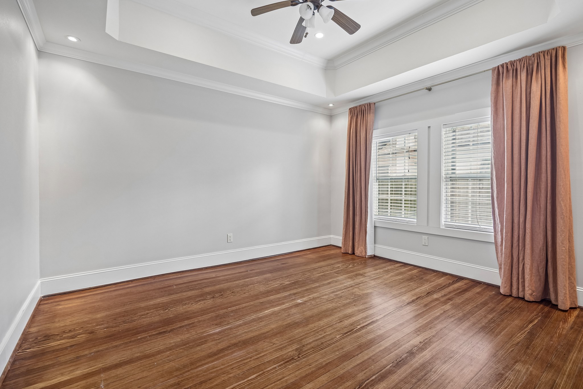4412 Rusk Street Houston, TX 77023 - Photo 21 of 44 Spacious secondary bedroom boasts trayed ceilings, recessed lighting, deep baseboards, crown molding, window coverings & gorgeous hardwood floors!