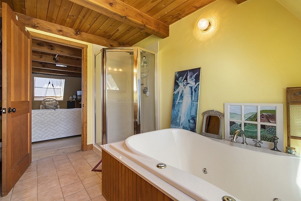 178 Wallace Hill Road Townsend, MA 01469 - Photo 14 of 42 a bathroom with a tub a sink and a large mirror of shower