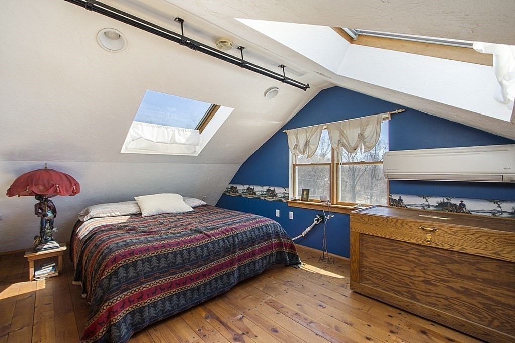 178 Wallace Hill Road Townsend, MA 01469 - Photo 19 of 42 a bedroom with a bed and a dresser next to a window