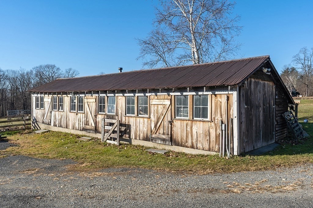 178 Wallace Hill Road Townsend, MA 01469 - Photo 28 of 42 a backyard of a house with yard and outdoor seating