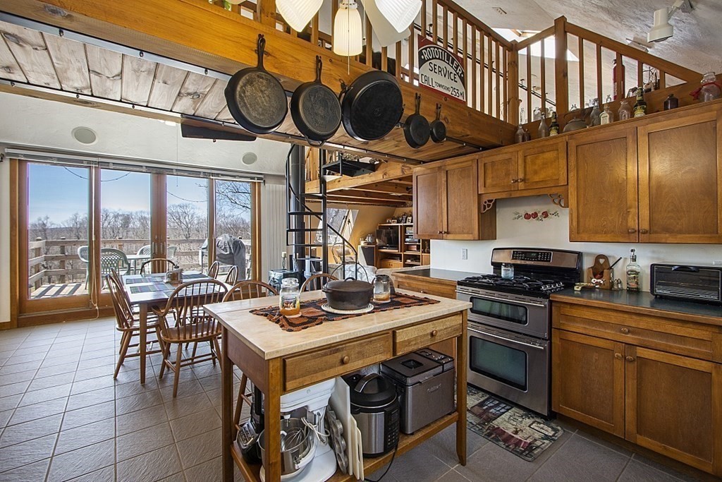 178 Wallace Hill Road Townsend, MA 01469 - Photo 4 of 42 a kitchen with stainless steel appliances granite countertop a stove a sink and a microwave