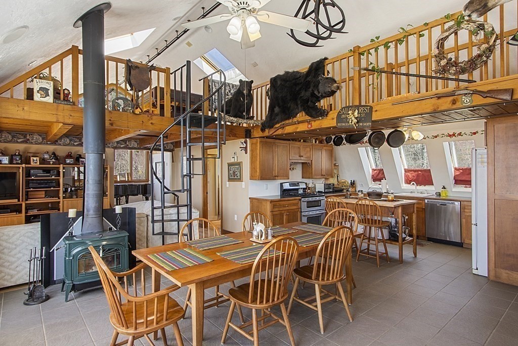 178 Wallace Hill Road Townsend, MA 01469 - Photo 7 of 42 a table and chairs in front of a building