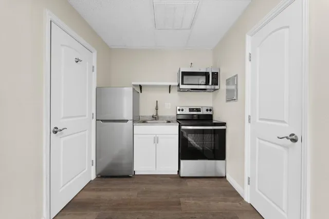 a kitchen with a refrigerator and a stove