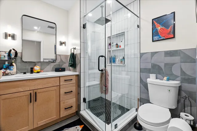 a bathroom with a toilet a sink and glass door