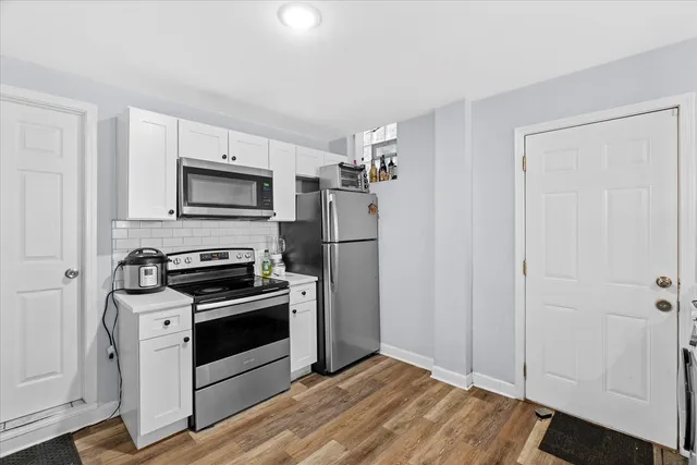 a kitchen with a refrigerator stove and microwave