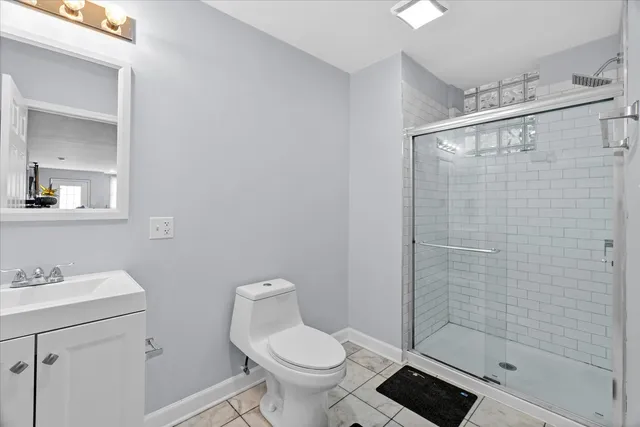 a bathroom with a shower a toilet and sink