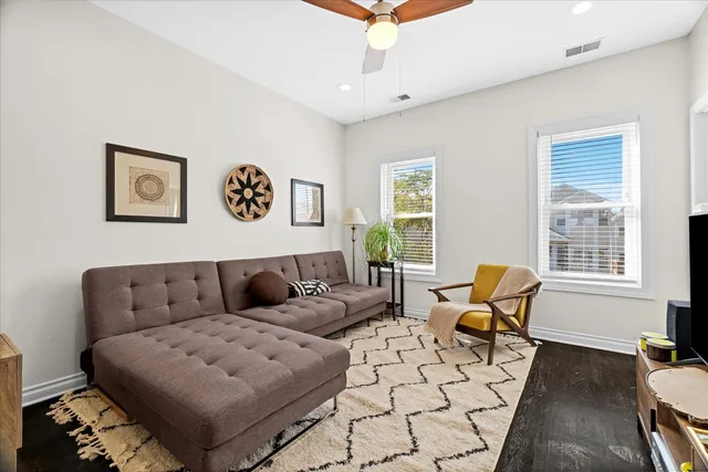 a living room with furniture and wooden floor