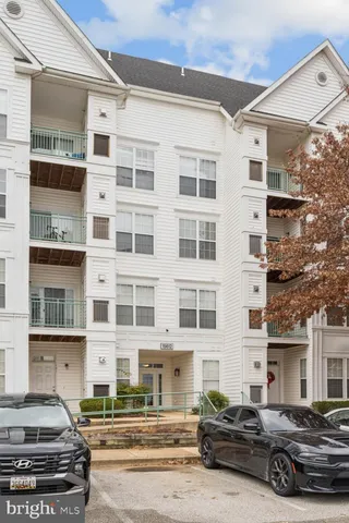 a car parked in front of a white building
