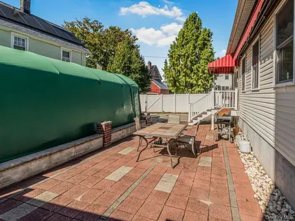 a backyard of a house with table and chairs